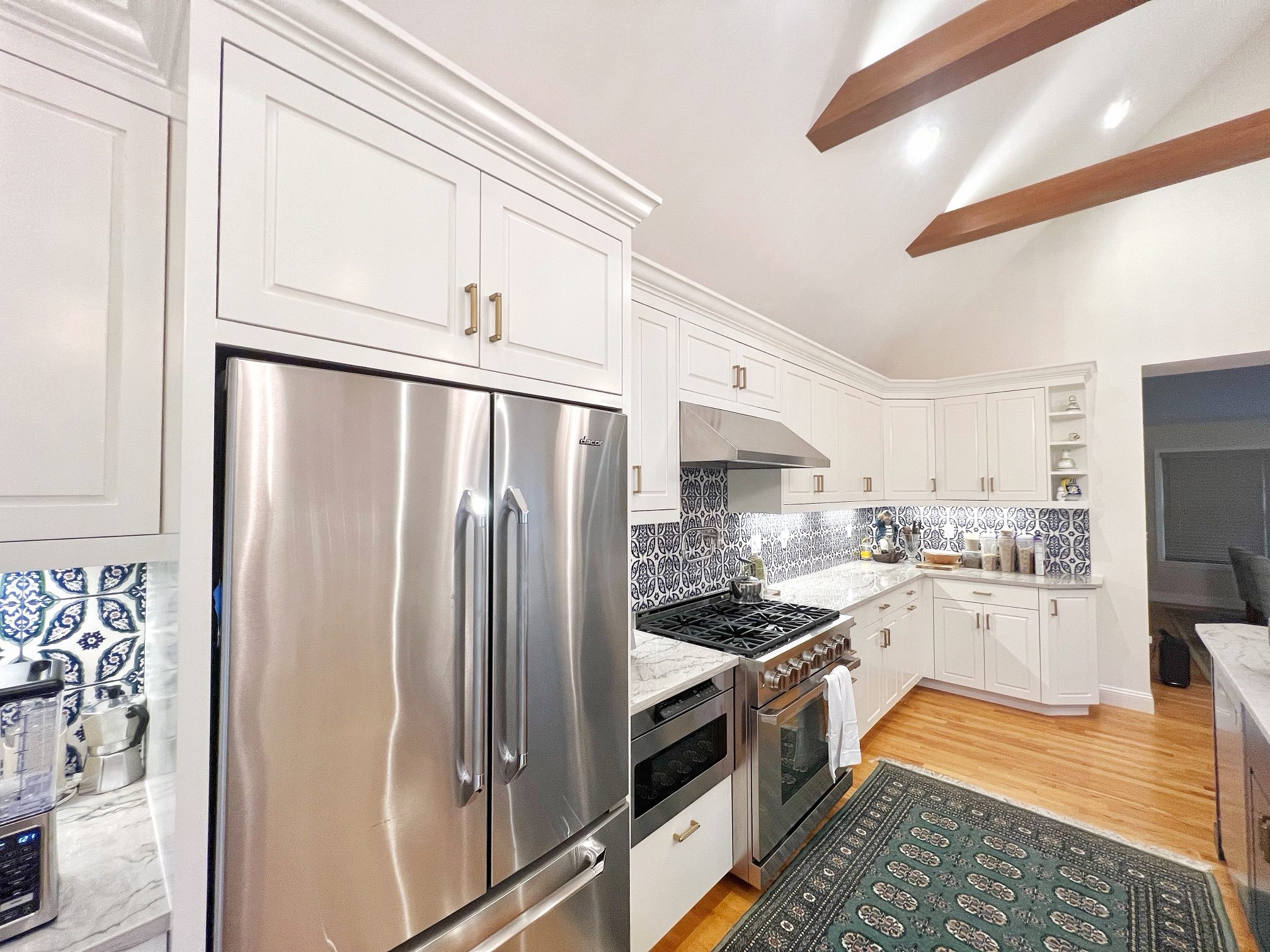 East Hampton kitchen with custom inset cabinetry and exposed beams